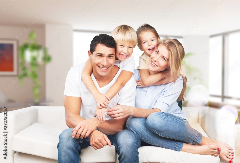 Young family at home smiling at camera Young family at home smiling at camera