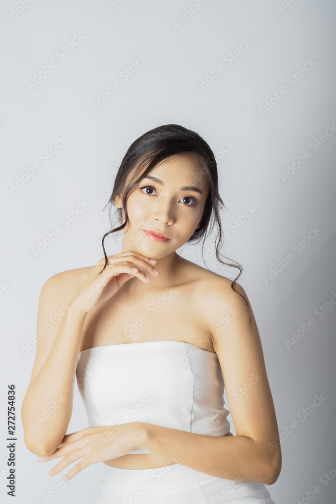 Beauty face woman show young facial treatment with spa and skincare in white dress Beauty face woman show young facial treatment with spa and skincare in white dress