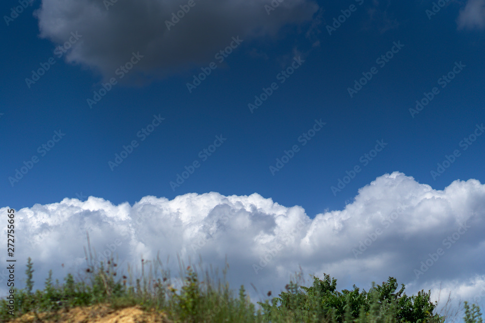 Fototapeta premium Dark storm clouds against blue sky. Sky before the storm