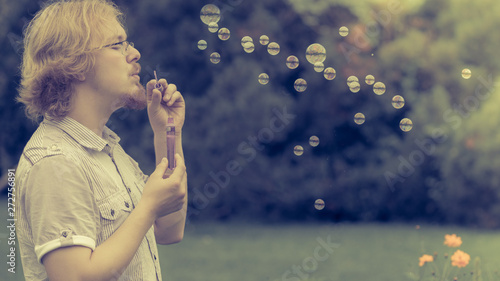 man blowing soap bubbles  having fun