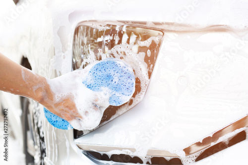 people man holding hand blue sponge for washing car. Concept car wash clean.