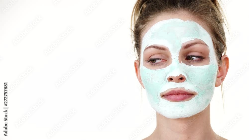 Young woman with white green mud mask on her face. Teen girl taking care of oily skin, cleaning the pores. Beauty treatment. Skincare. Young woman with white green mud mask on her face. Teen girl taking care of oily skin, cleaning the pores. Beauty treatment. Skincare.