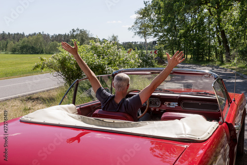 Senior Man in the red Ford Mustang Cabriolet © kelifamily