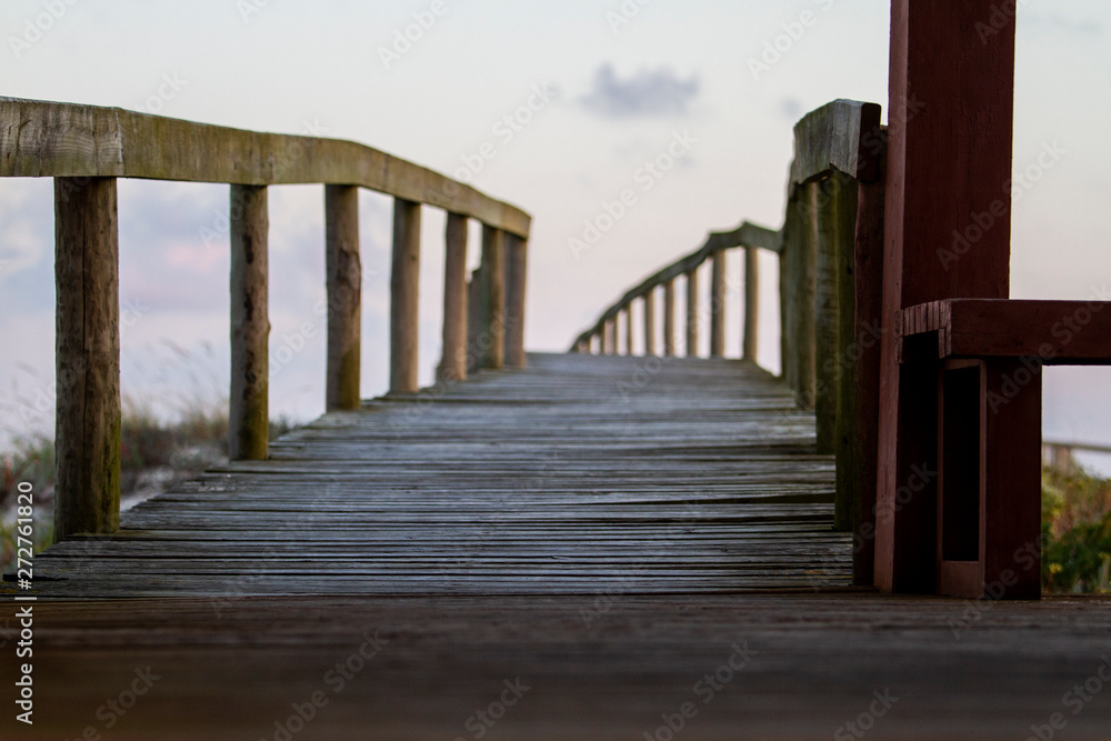 wooden bridge over sand dune