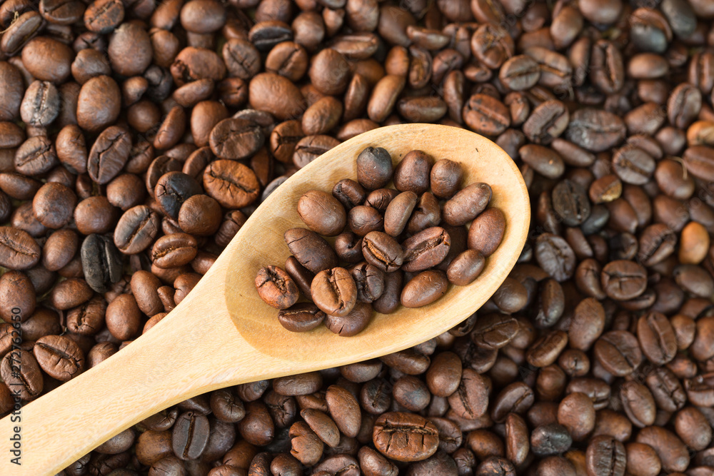 Coffee beans in the spoon wooden Coffee beans in the spoon wooden
