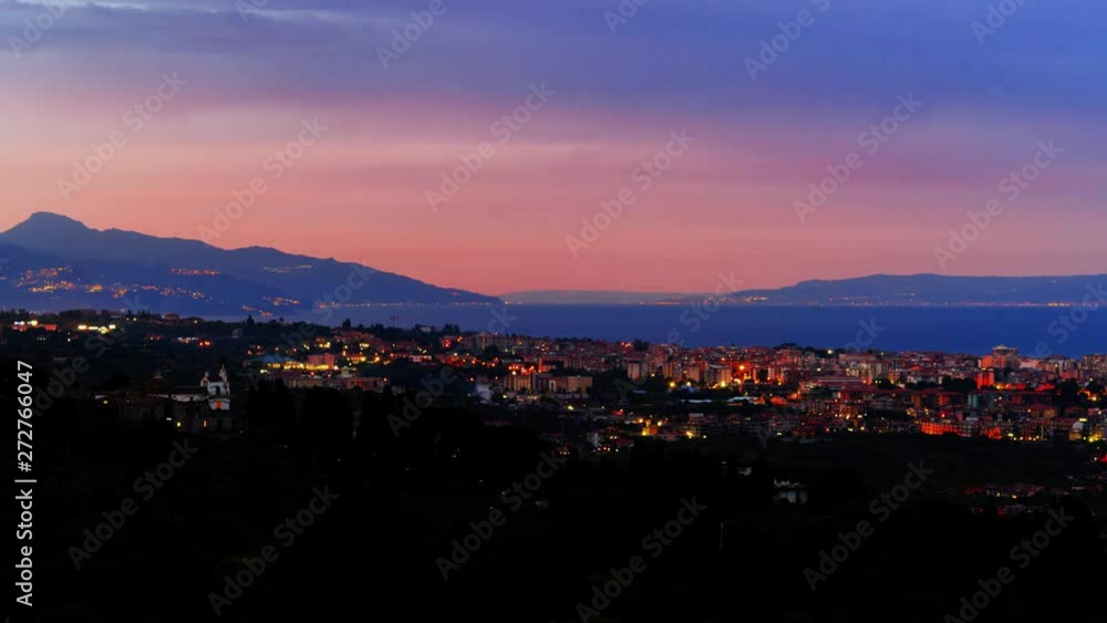 Timelapse day to night view of a sunset on the town of Acireale in Sicily, with the southern tip of Italy on the background Timelapse day to night view of a sunset on the town of Acireale in Sicily, with the southern tip of Italy on the background