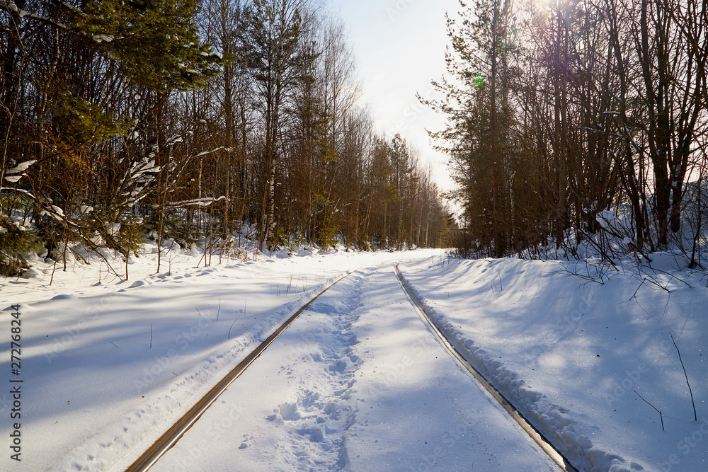 Winter railway rails in the snow. Rails go into the distance Winter railway rails in the snow. Rails go into the distance