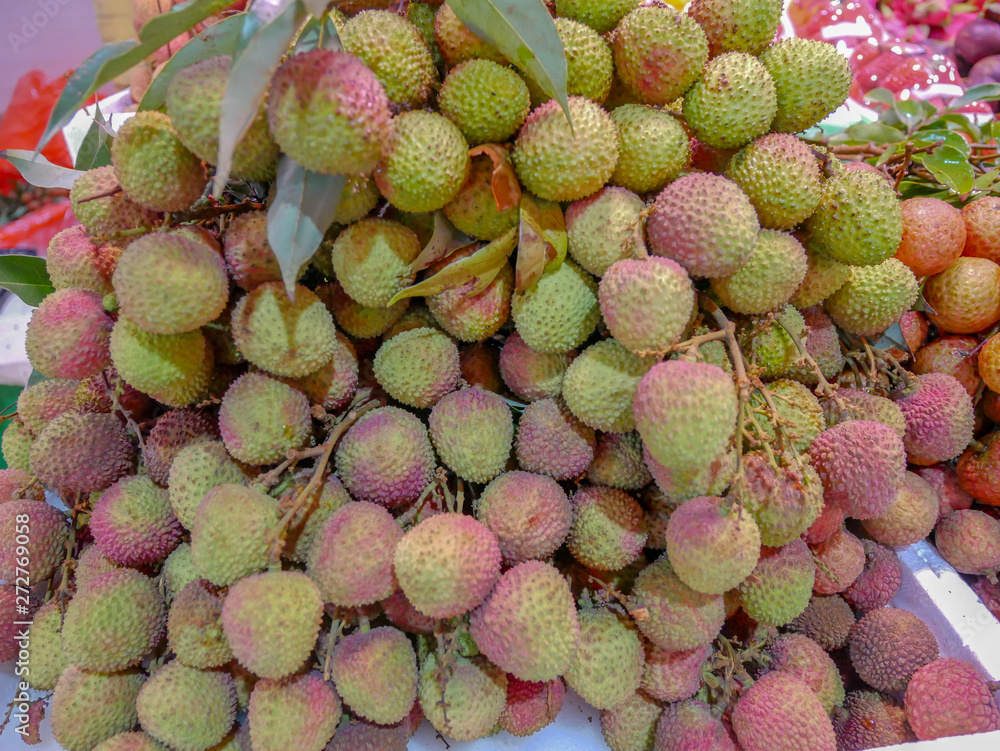 Many fresh lychee fruits at the market Many fresh lychee fruits at the market