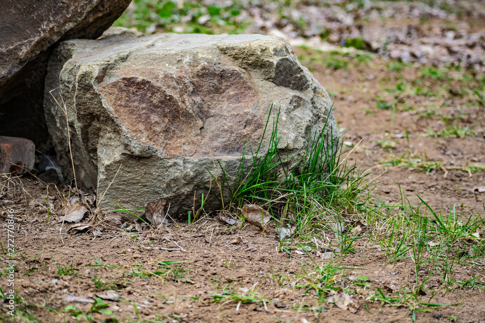 Spring, big hard stones in nature among the small vegetation, under the open sky. Spring, big hard stones in nature among the small vegetation, under the open sky.