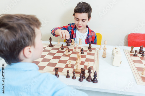 Family playing chess in tournament room photo