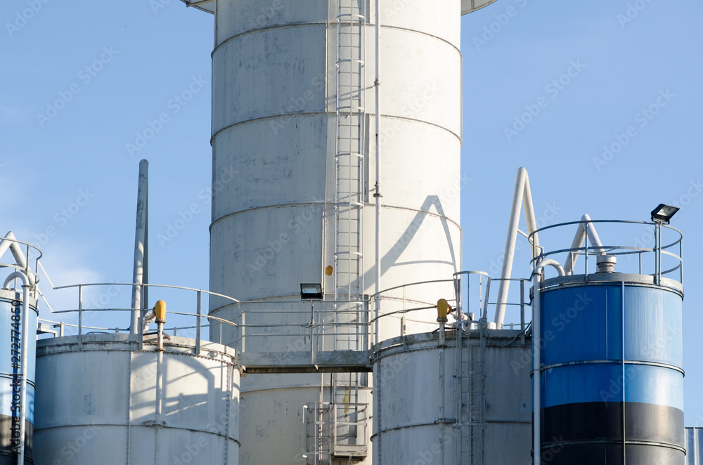 steel tower, with ramps and storage silos, in an industry that produces cement. steel tower, with ramps and storage silos, in an industry that produces cement.