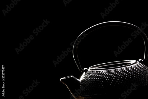Tea pot on black background