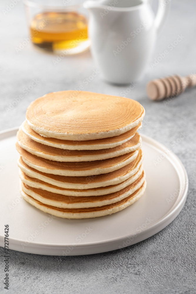 Pancakes stack with butter and honey. Grey backround. Pancakes stack with butter and honey. Grey backround.
