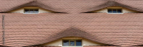 Obraz na plátně Semi-circular windows in the roof in a country cottage