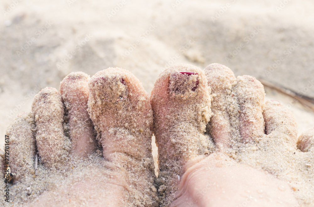 Female legs and sand of a summer beach Female legs and sand of a summer beach