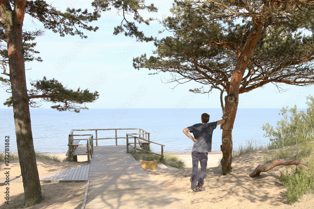 Man looking to beach of Baltic sea in morning. Man on sandy beach of the Baltic Sea in Palanga, Lithuania.