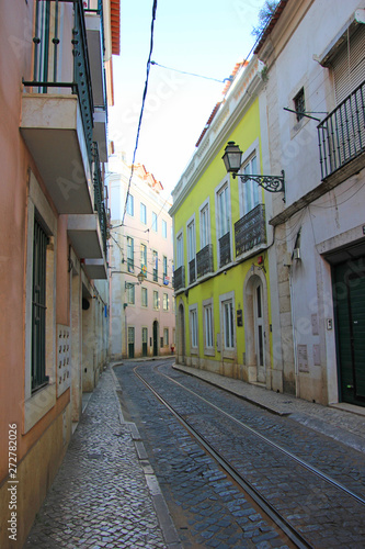 narrow alley in the old town alfama in lisbon, portugal © Luciernaga