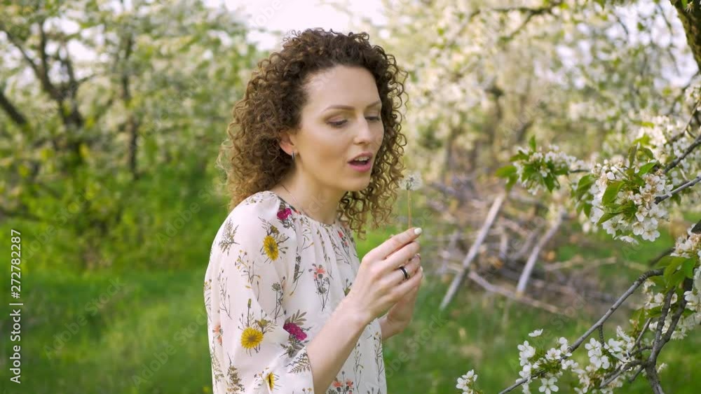 Portrait young attractive redhead woman with curly hair are walking in spring blossom park. Enjoy fresh nature. Portrait young attractive redhead woman with curly hair are walking in spring blossom park. Enjoy fresh nature.