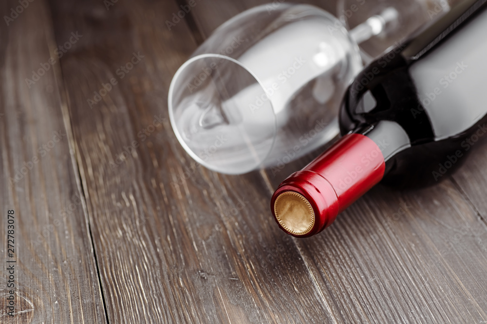 Glass bottle of wine with corks on wooden table background.Top view with copy space Glass bottle of wine with corks on wooden table background.Top view with copy space