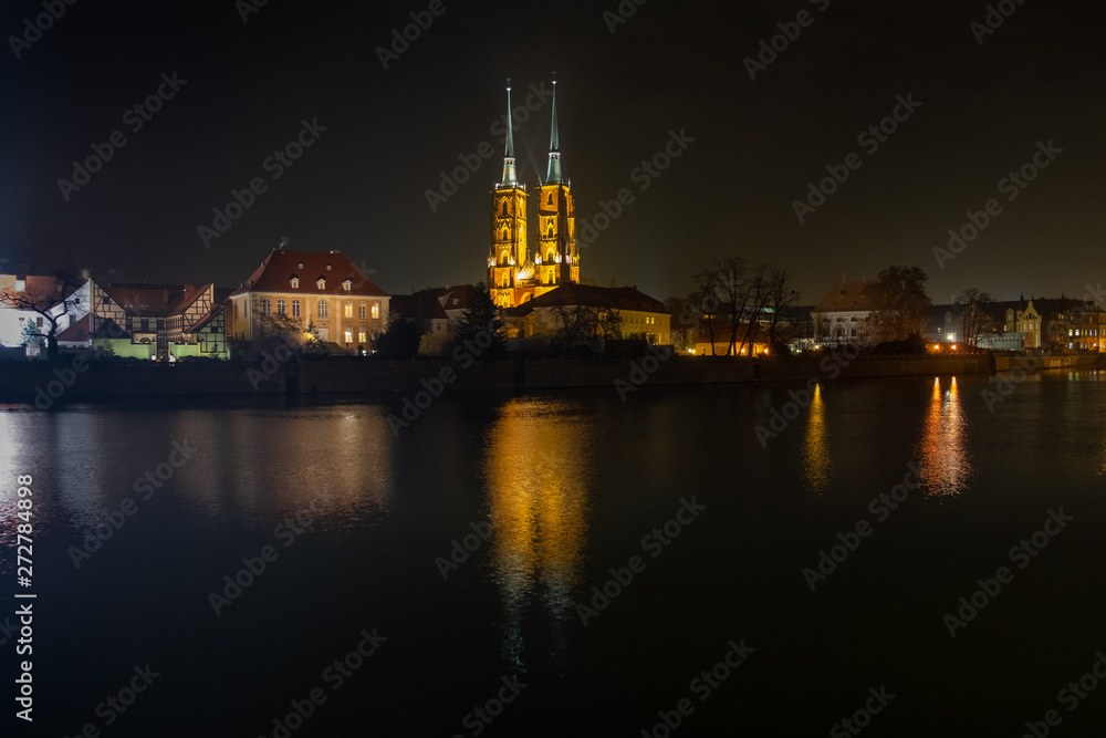 Amazing night view of the Cathedral of St. John the Baptist reflected in Oder river. Ostrow Tumski district. Wroclaw. Poland