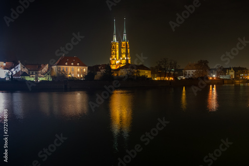 Amazing night view of the Cathedral of St. John the Baptist reflected in Oder river. Ostrow Tumski district. Wroclaw. Poland