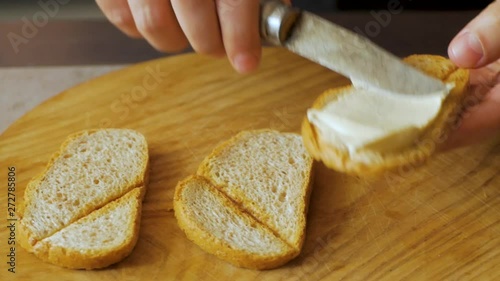 man cook hands making toast with hummus