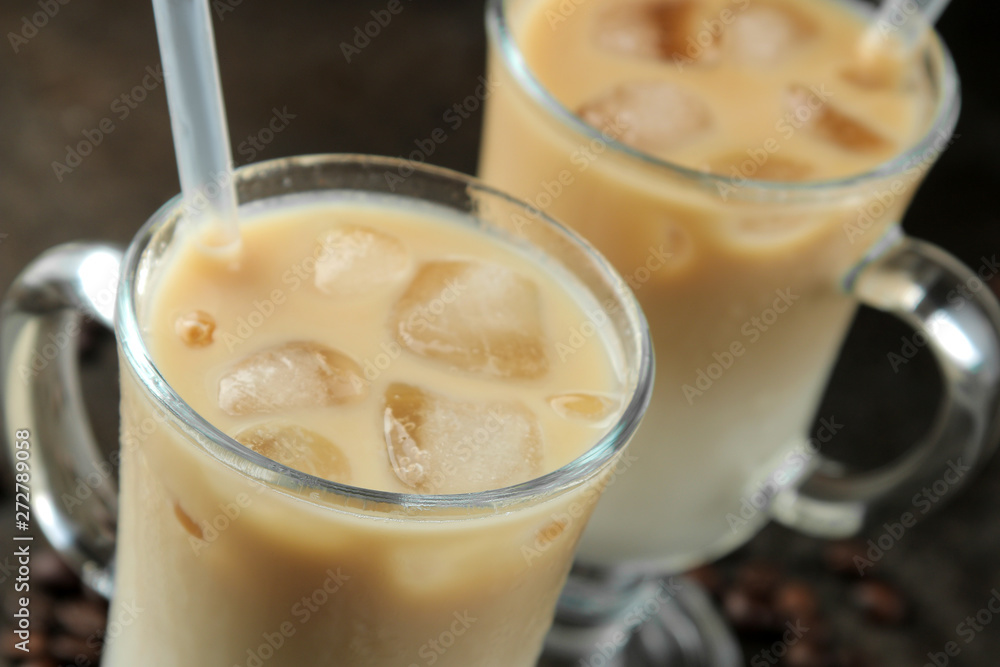 Ice latte or Iced coffee with milk and ice cubes in a glass beaker against a dark background. refreshing drink. summer drink. Ice latte or Iced coffee with milk and ice cubes in a glass beaker against a dark background. refreshing drink. summer drink.