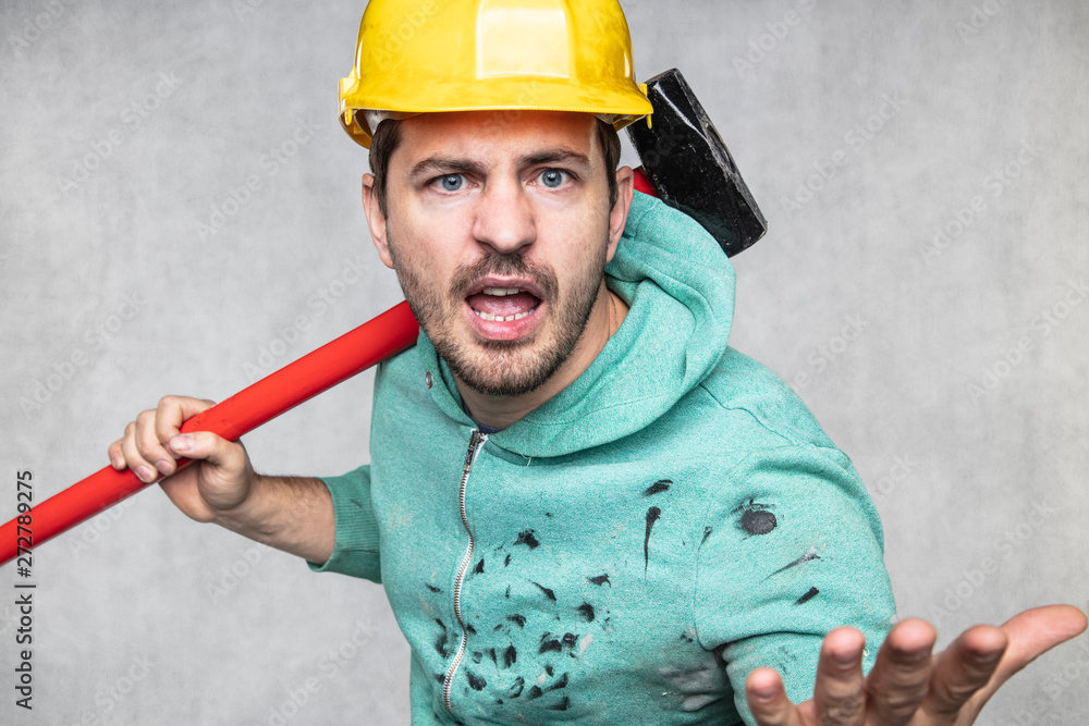 construction worker with a hammer in hand, concept of construction and disassembly, renovation construction worker with a hammer in hand, concept of construction and disassembly, renovation