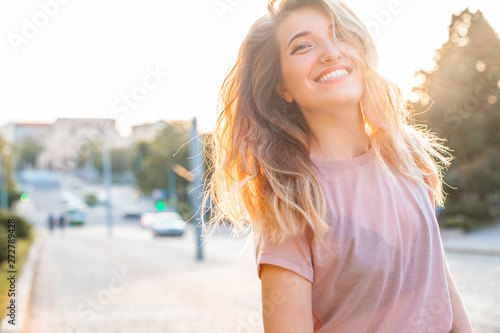 Happy young woman walking in the city,