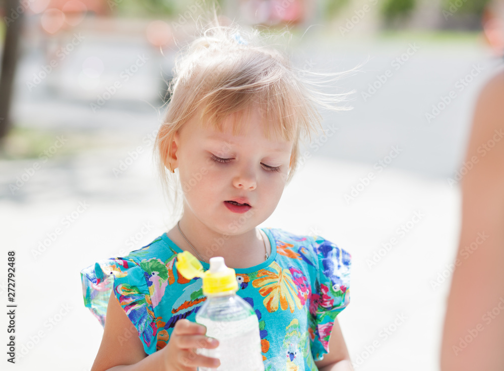 Adorable child baby drinking water from bottle Adorable child baby drinking water from bottle