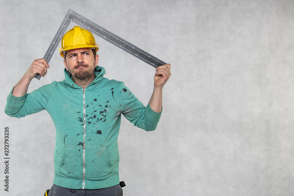 the construction worker is holding a angle in the hand, a guide to constructing right angles