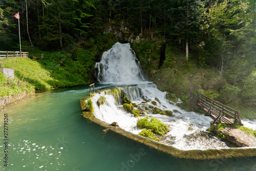 idyllic waterfall surrounded by green forest landscape photo