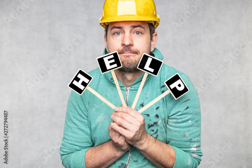construction worker holding a blackboard with space for text or text, copy space, 