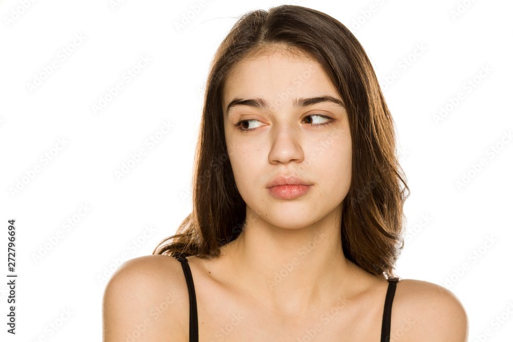 Young beautiful woman without makeup looking aside on white background Young beautiful woman without makeup looking aside on white background