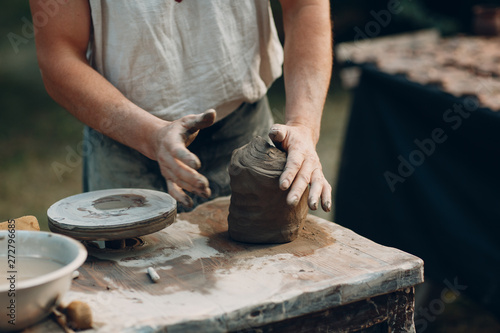 Potter makes clay pot jar on potter's wheel