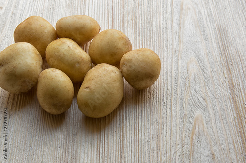 new potatoes, early potatoes, vegetables on a wooden background