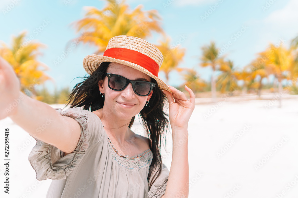 Boyfriend following girlfriend holding hands on white wild beach laughing and smiling Boyfriend following girlfriend holding hands on white wild beach laughing and smiling