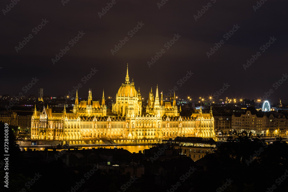 Illuminated aerial urbanscape of Budapest with the Parliament building at the Danube River by night.