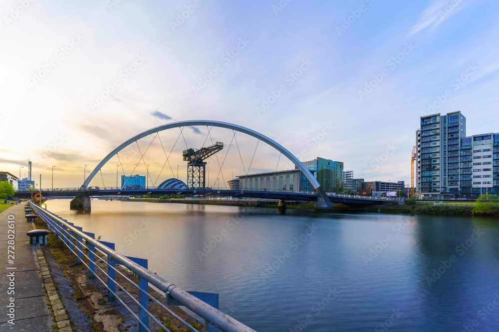 The Clyde Arc Bridge or the Squinty Bridge crossing the river Clyde in twilight in Glasgow , Scotland , UK