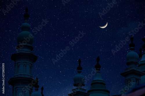 Top of mosque in Eid Ul fitr night with moon and star in sky