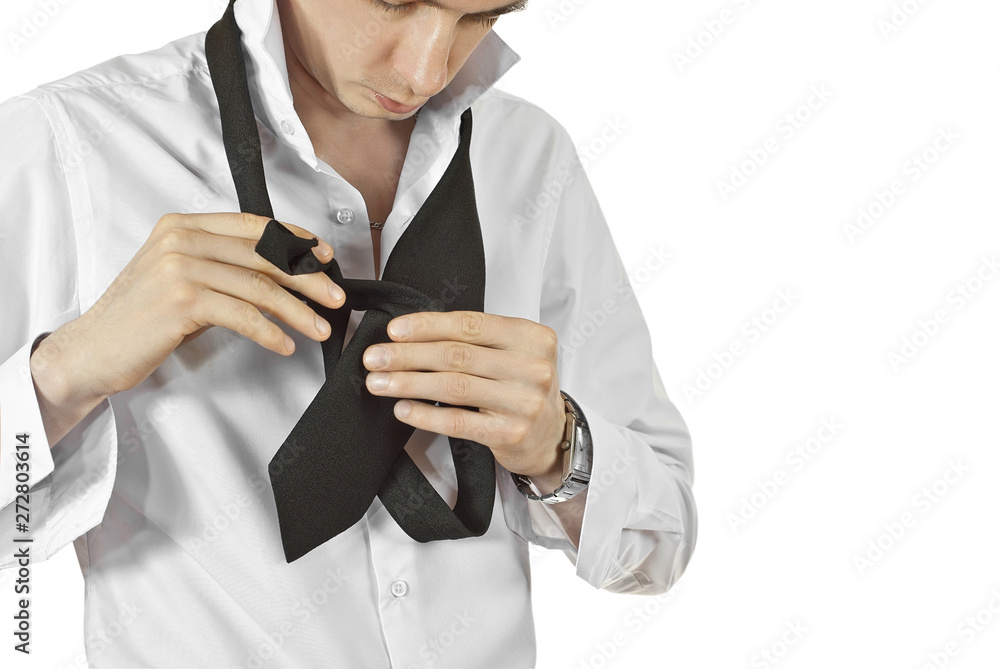 Image showcasing A man tied a tie. Preparing for a wedding day. The guy is learning to ...