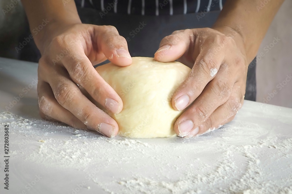 hands of baker kneading dough hands of baker kneading dough