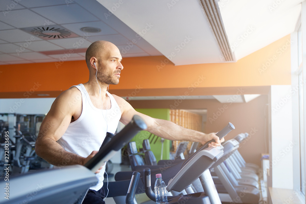 Fototapeta premium Man doing cardio training on treadmill