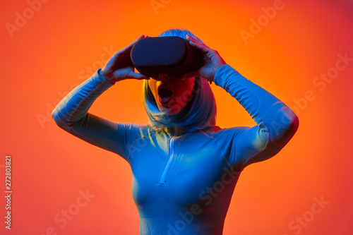 Futuristic woman in VR glasses screaming
