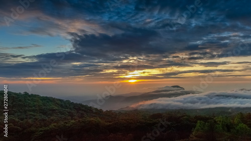 sunrise at Doi Inthanon, Km. 41 view point, mountain view misty morning on top hill panorama 180 degrees with sea of mist in valley and yellow sun light in the sky background, Chiang Mai, Thailand. © Yuttana Joe