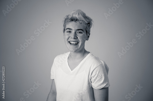 Portrait of attractive cheerful transgender young man with smiling happy face. Human expressions and emotions