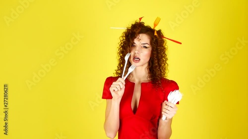 Wallpaper Mural Young beautiful woman in a red dress on a yellow background. Female portrait with plastic forks in hair. Environmental protection concept. Torontodigital.ca