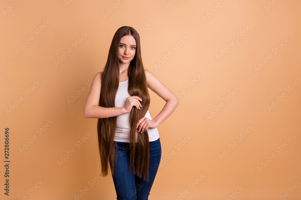 Close up photo beautiful amazing her she lady hold arms very long brown  hair great condition curls show results after lamination wear casual white  tank-top jeans denim isolated pastel beige background Stock