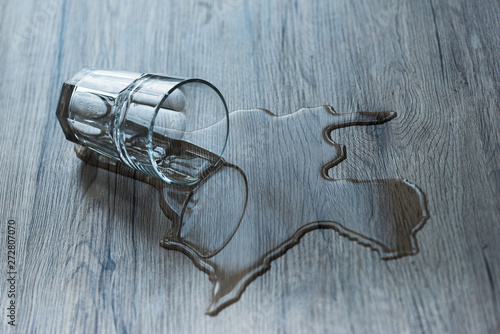 Obraz na plátně glass with spilled water on textured wooden surface