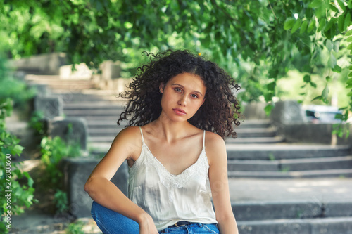 Portrait of a young girl in the city . Slim model in jeans and light blouse Free Download Portrait of a young girl in the city . Slim model in jeans and light blouse - GFXLoad